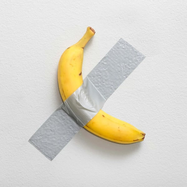 A banana duct-taped to a white gallery wall